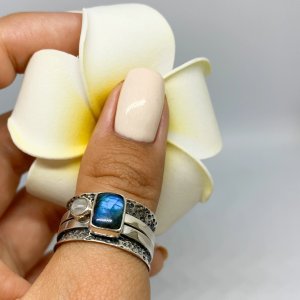 Rectangular labradorite and moonstone ring on dark base